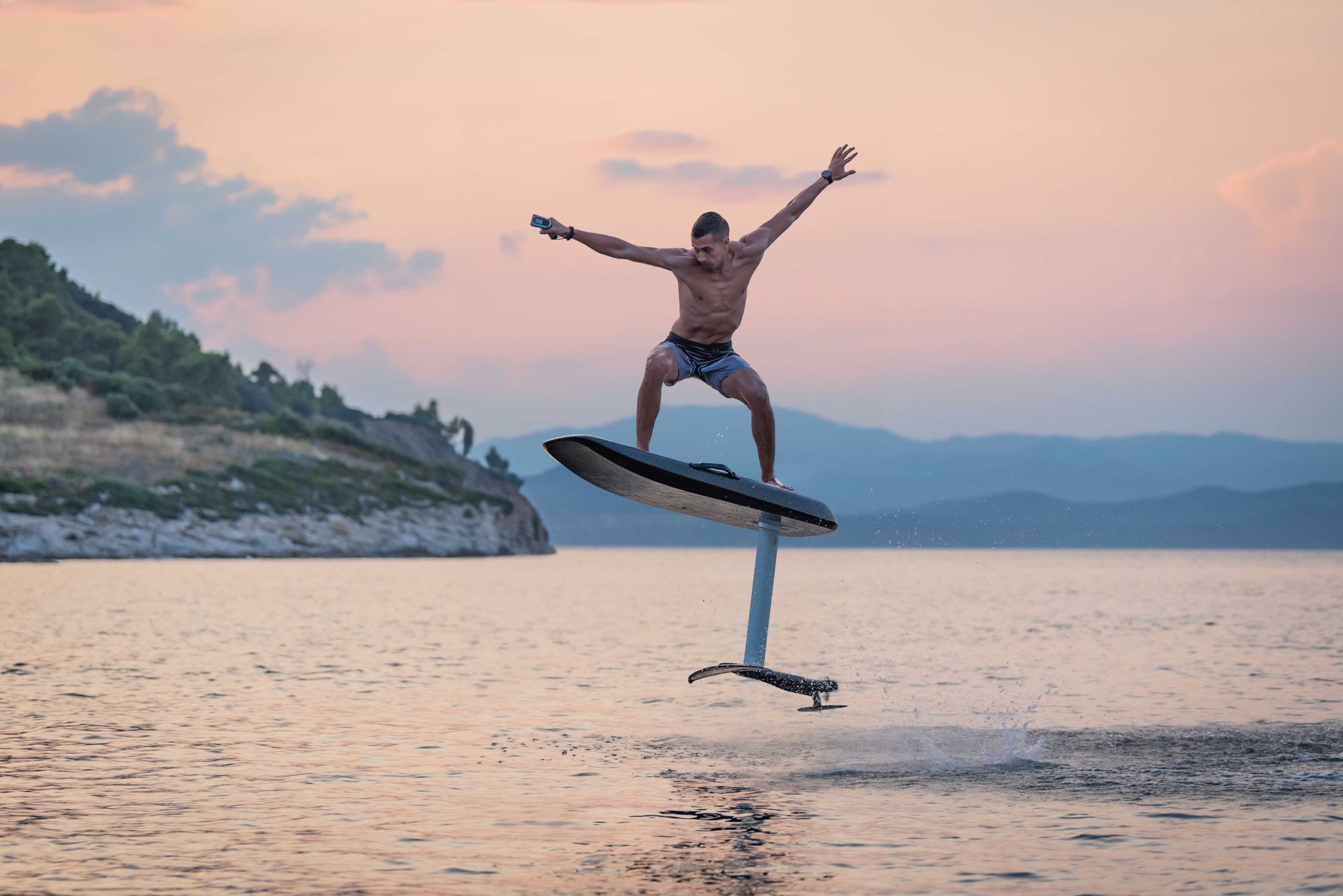 eFoil rider above the Ionian sea at sunset